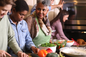 Multi-ethnic family members work together in grandmother's home kitchen 